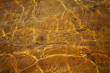 Ripples on the surface of the sea lit by the sun