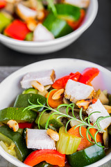Tasty ratatouille made of zucchini, carrots, peppers and grilled chicken