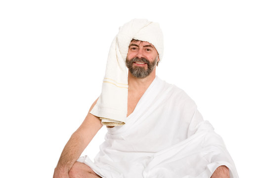 Joyful man dressed in the sauna in a turban. From a series of Russian bath.