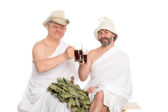 Friends in traditional bathing costumes drink kvas - bread drink. From a series of Russian bath