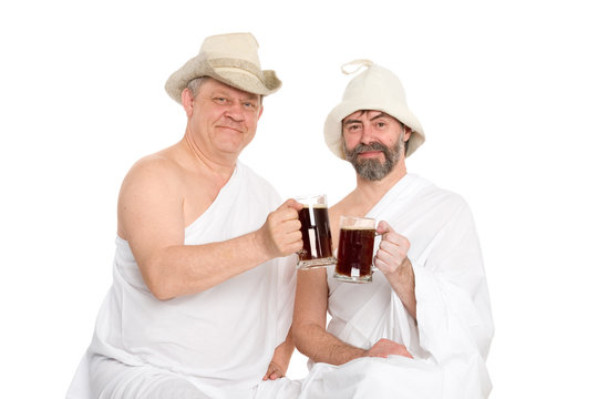 Men in traditional bathing attire drink kvas - bread drink. From a series of Russian bath.