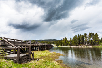 Lake showing the sky with clouds and reflections on mountains and clouds in the water in the heart of Yellowstone National Park near West Yellowstone, Wyoming, USA 