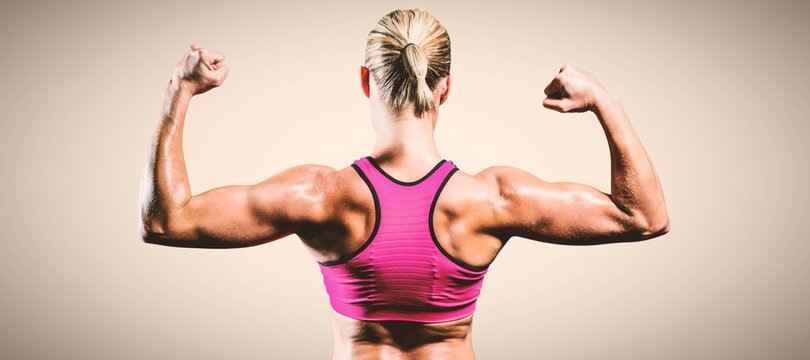 Composite image of muscular woman flexing her arms 