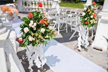 wedding arch with chairs and many flowers and decor