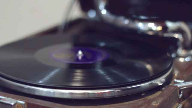 Old gramophone playing music with female hand (no audio)