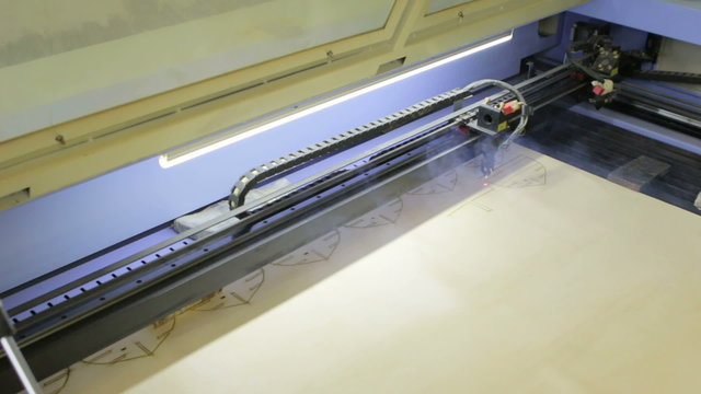 Laser cutting machine at work.  Cuting patterns for ship model