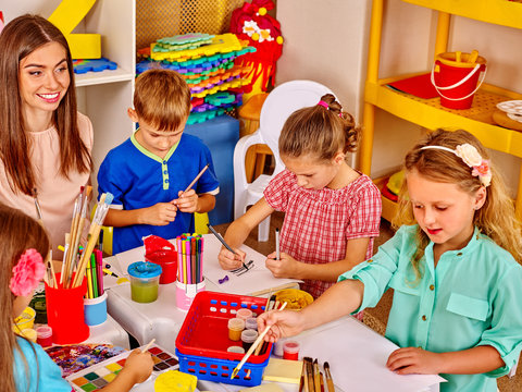 Group kids with teacher woman learnig painting on paper  in  kindergarten . 