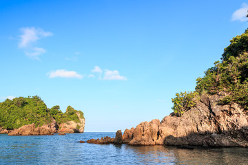 Fototapeta na wymiar Background stone beach, with blue sky and sand