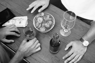 View on friends having alcoholic drinks in the bar, close-up