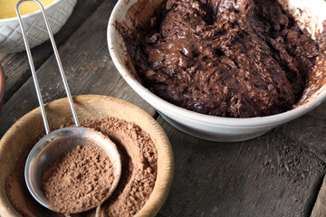 Preparing dough for chocolate pie on table close up