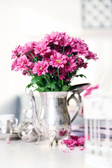 Fototapeta na wymiar Beautiful flowers in vase on table in room
