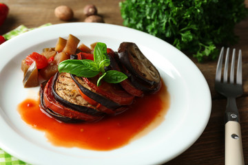 Ratatouille on plate, on table background