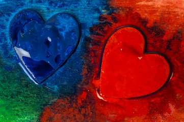 Three-dimensional hand-painted red and blue hearts on a colored background. Gift for Valentine's Day.