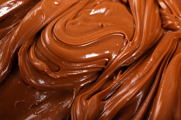 Background of thick melted milk chocolate, close-up