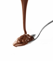 Melted milky brown chocolate pouring from a spoon, isolated on white