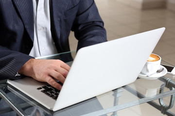 Businessman having lunch and working in a cafe, close-up