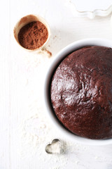 Cooked chocolate pie in a baking tray on a table, top view