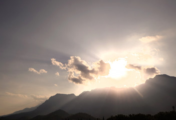 Blue sky with clouds and mountains peak