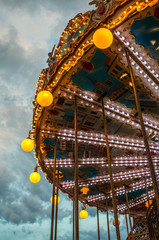 PARIS, FRANCE - AUGUST 30, 2015: Old French carousel in a holiday park at night summer time. © Unique Vision