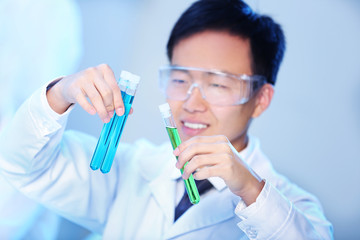 Young male medical technician working in laboratory