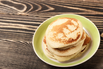 stack of pancakes on wooden board