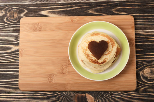 stack of pancakes on wooden board