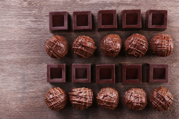 Delicious chocolate candies on wooden background