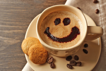Cup of coffee on wooden table background