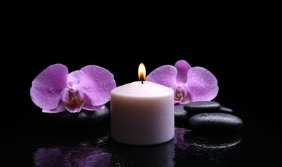 Obraz na płótnie Canvas Composition of orchid, pebbles and candle on dark background