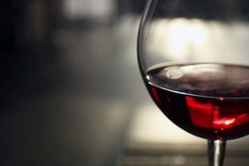 Glass of red wine on blurred background