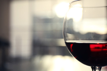 Glass of red wine on blurred background