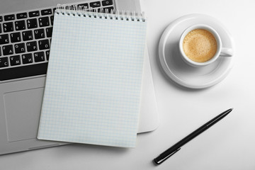 Empty  notebook on laptop keyboard, on light background