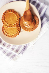 Melted chocolate onplate, on wooden background