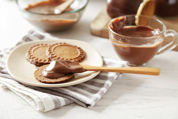 Melted chocolate onplate, on wooden background