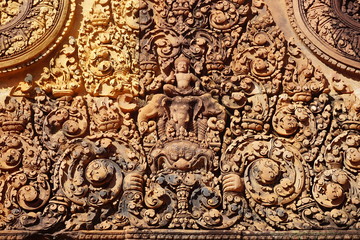 Fototapeta na wymiar Carved friezes on the Banteay Srei (srey) temple near Angkor, Cambodia