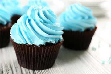 Blue cupcakes on wooden table