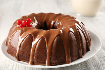 Chocolate cake with a bottle of milk on a table