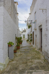 Narrow street of Alberobello, ancient district. World Heritage Site.