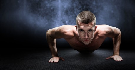Obraz premium Composite image of confident shirtless athlete doing push ups