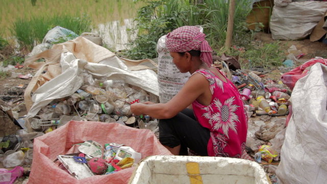 Garbage gatherers assorting trashes in slums