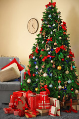 Christmas fir tree with gifts in living room