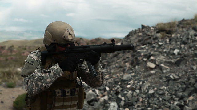 Soldier shooting automatic small target rifle at range single fire.