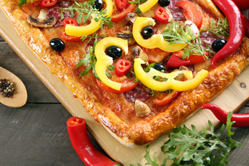 Rectangle delicious pizza and vegetables on the table, close-up