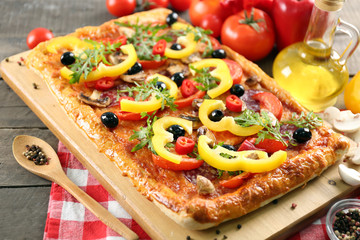 Rectangle delicious pizza and vegetables on the table