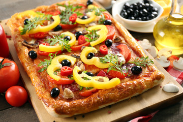 Rectangle delicious pizza and vegetables on the table