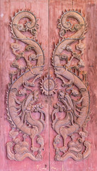Dragon carved pattern on the wooden texture of door