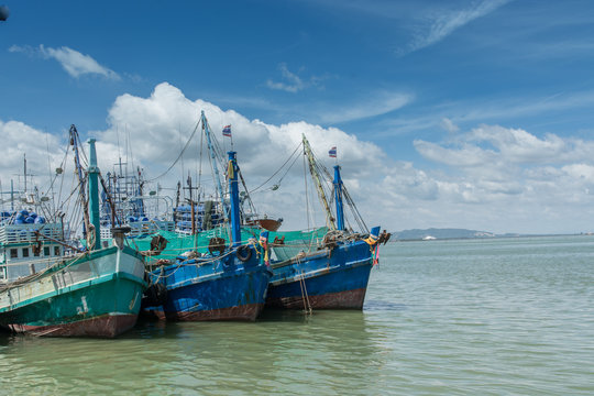Thai wooden fishing boats in harbor, Thailand