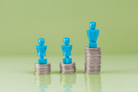 Male and female figurines standing on top of coins