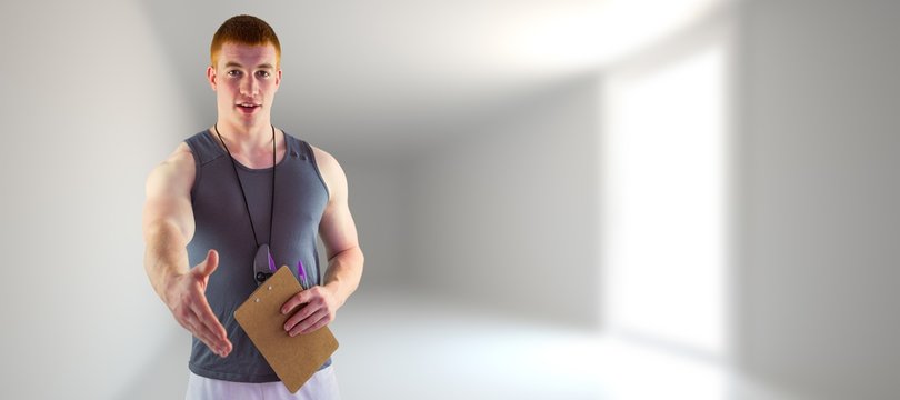 Composite image of welcoming personal trainer giving handshake