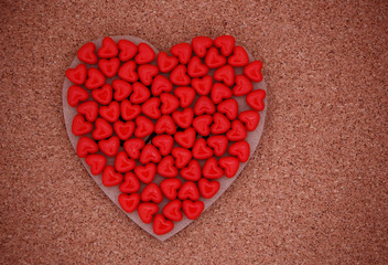 red heart shaped beads on wooden valentine